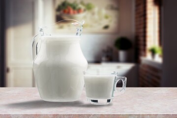 Tasty fresh milk into glass at light kitchen