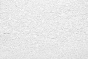 Textured white paper surface with subtle wrinkles and folds for artistic applications.