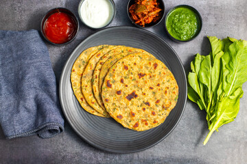 Palak paratha is a soft, spinach-filled flatbread, served with creamy, spiced palak paneer—a flavourful spinach and cottage cheese curry.