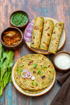 Palak paratha is a soft, spinach-filled flatbread, served with creamy, spiced palak paneer&mdash;a flavourful spinach and cottage cheese curry.