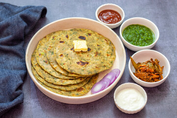 Palak paratha is a soft, spinach-filled flatbread, served with creamy, spiced palak paneer—a flavourful spinach and cottage cheese curry.