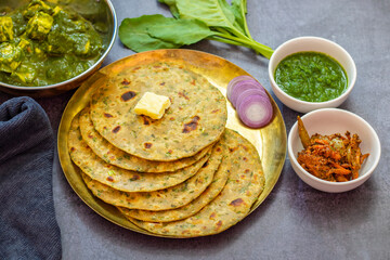 Palak paratha is a soft, spinach-filled flatbread, served with creamy, spiced palak paneer—a flavourful spinach and cottage cheese curry.