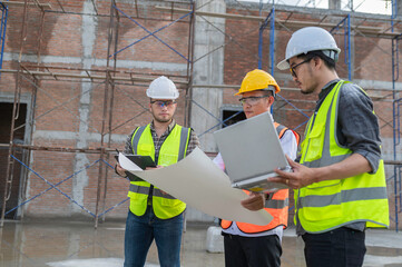 Three Asian engineer working at site of a large building project,Work overtime at construction...
