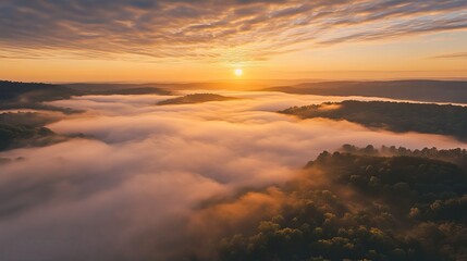 Fototapeta premium A breathtaking sunrise over misty valleys and forests, showcasing nature's beauty.