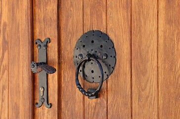 Wooden doors of residential houses with wrought iron handles