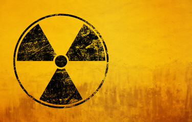 Black radioactive sign over yellow background