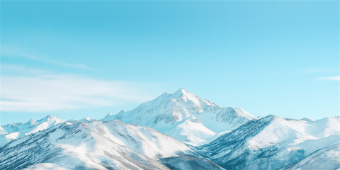 Fototapeta premium A stunning view of snow-capped mountains under a clear blue sky. The tranquil landscape captures the beauty of winter and the serene nature of the peaks.