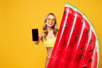 Young woman wear bikini swimsuit sunglasses rest near hotel pool hold inflatable mattress use blank...