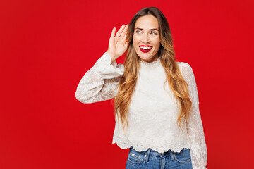 Young curious nosy smiling happy Caucasian woman she wear white blouse casual clothes try to hear...