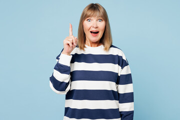 Elderly proactive blonde woman 50s years old wear striped sweatshirt casual clothes holding index...
