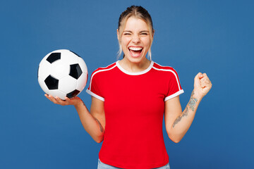 Young woman fan wear basic red t-shirt cheer up support football sport team hold in hand soccer...