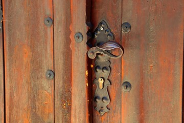 Wooden doors of residential houses with wrought iron handles