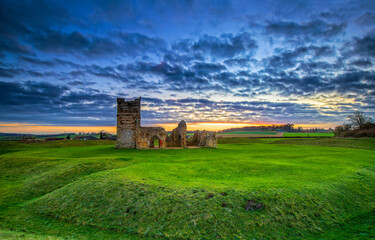 ruins of castle in field at dawn