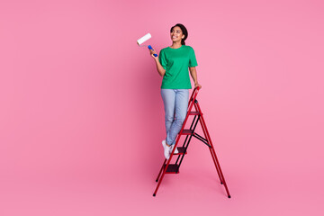 Full size photo of pretty young girl climb ladder look empty space wear trendy green outfit...