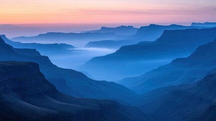 Obraz premium a blue mountainous landscape at dusk with mist