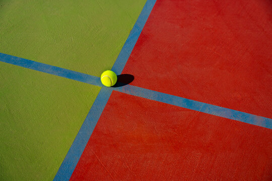 Tennis ball on the colorful court close-up view