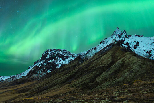 Auroras over snowy Icelandic peaks