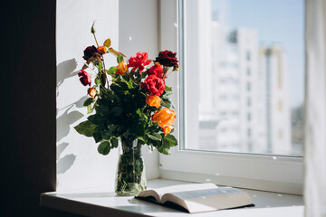 Flowers and Bible on a Sunlit Windowsill