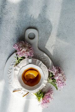 Elegant autumn tea setup with chrysanthemums and citrus