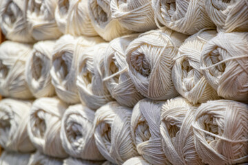 A collection of soft white yarn balls, perfect for crafting and knitting projects