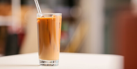 Glass of tasty iced coffee on table
