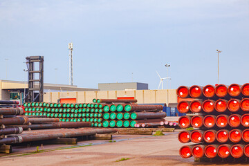 Open warehouse for storing steel pipes of various diameters on the territory of the seaport.