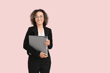 Fototapeta premium Happy mature businesswoman in eyeglasses with folder on pink background