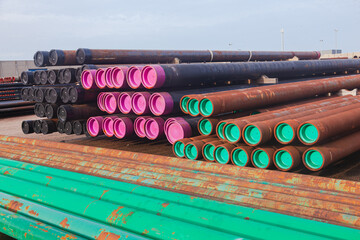 Open warehouse for storing steel pipes of various diameters on the territory of the seaport.