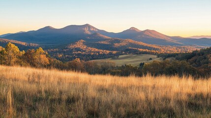 Obraz premium mountain landscape with golden fields and autumn colors at sunset