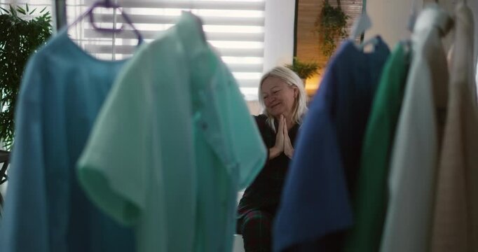 Female female nurse stretches in the morning after waking up, gets from bed, and comes to the wardrobe to get the uniform, getting ready to go to work