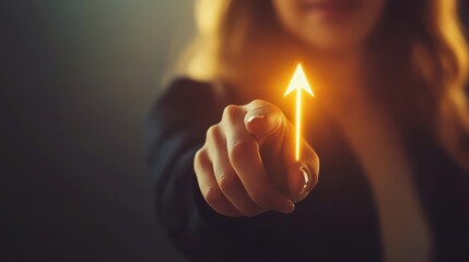 Closeup of Businesswoman Pointing with a Hand at a Bright Arrow Symbolizing Success and Growth in a Professional Setting