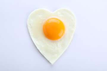 Heart shaped fried egg isolated on white, top view