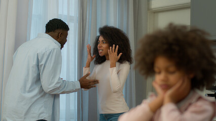 African American family problem quarrel conflict arguing parents angry man father male husband argue yelling screaming mad woman female mother domestic violence upset little child kid girl daughter