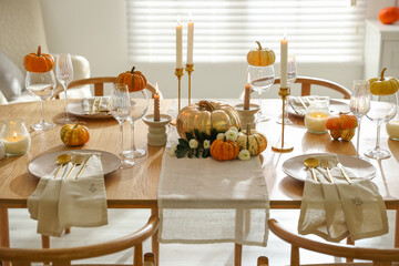 Stylish dining room with beautiful table setting and autumn decor