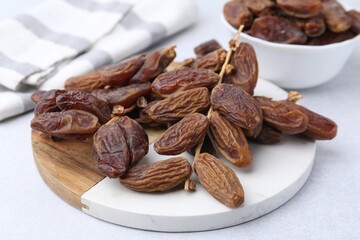 Tasty dried dates on light table, closeup