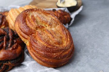 Different delicious pastries on grey table, closeup. Space for text