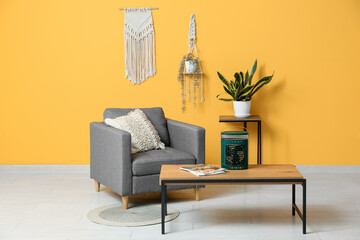 Portable table fan with humidifier on coffee table, armchair and houseplant in room