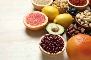 Different superfood products on white table, closeup