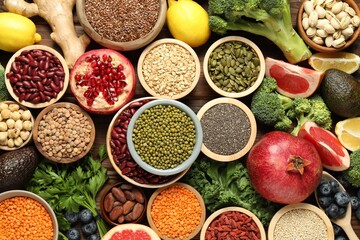Different superfood products on wooden table, flat lay