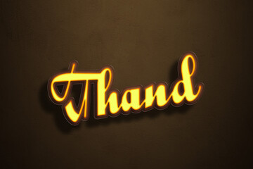 Yellow Neon Light Text Effect of Hindi word Thand on Golden background.