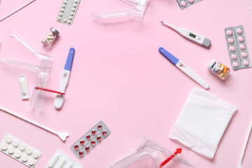 Frame made of gynecological supplies on pink background