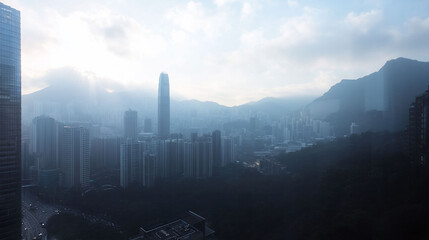 Fototapeta premium Foggy cityscape with mountains and skyscrapers in view.