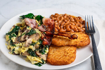 scramble eggs  with bacon, baked beans and  hash  browns