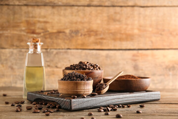 Composition with cutting board and coffee body scrub in bowl on wooden background