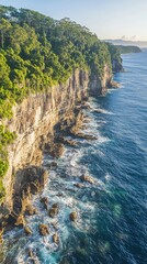 Obraz premium Dramatic drone view captures rugged cliffs and turquoise waters along the coastline at sunset