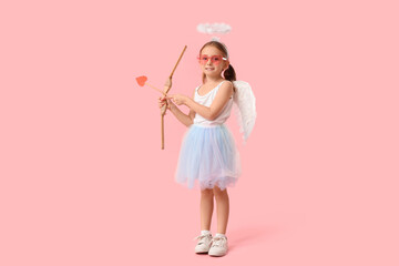 Cute little girl dressed as Cupid with arrow and bow on pink background. Valentine's Day celebration