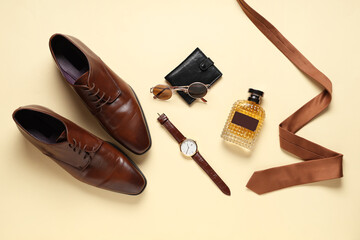 Stylish men's accessories with stylish leather shoes and perfume on beige background