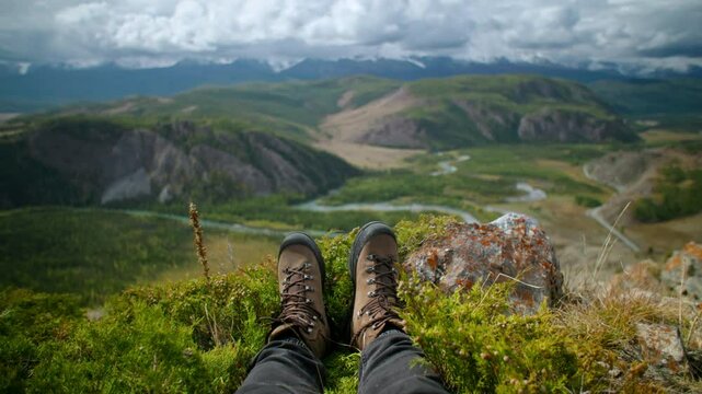 Close up boots travaler person enjoying the serene and breathtaking mountain views while relaxing on peaceful hike in the great outdoors