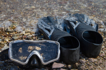Diving mask and flippers on the seashore. © Таня Микитюк
