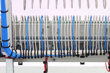 The reverse side of the electrical switchboard. The connected wires are tied with plastic ties.
